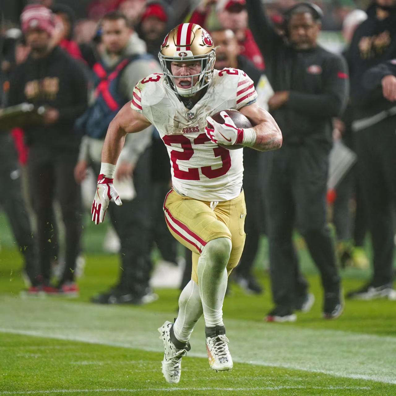 Christian McCaffrey running with the football
